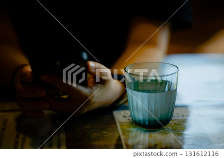 Glass water and female hands 131612116