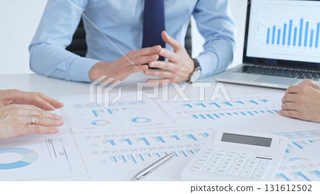 Business people having a financial meeting, discussing company strategy, reviewing data analysis, and planning future growth using charts and reports Business people having a financial meeting, discussing company strategy, reviewing data analysis, and planning future growth using charts and reports 131612502