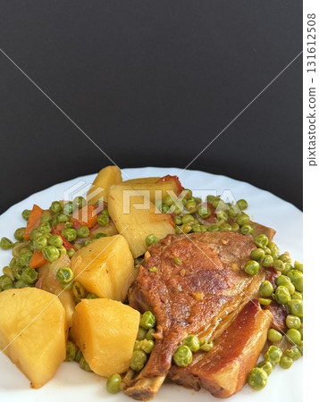 Pork chop with peas and potatoes. Delicious food cooked at home. Pork chop with peas and potatoes. Delicious food cooked at home. 131612508
