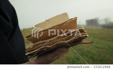 Book With Holy Scriptures Read By A Man In A Foggy Winter Park 131612898