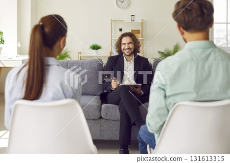 Smiling Psychologist During Family Therapy Session Smiling Psychologist During Family Therapy Session 131613315