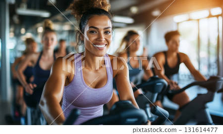 woman bike purple tank hair bun closeup gym 131614477