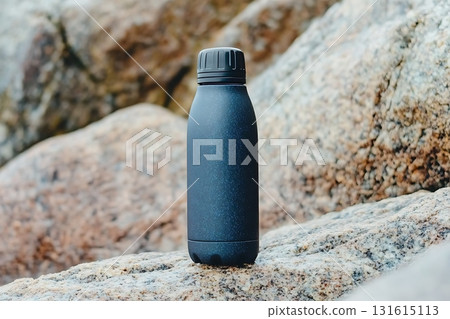 Black Insulated Water Bottle Standing on Rock Surface in Natural Outdoor Environment 131615113