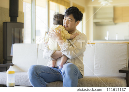 Dad holding a baby 131615187