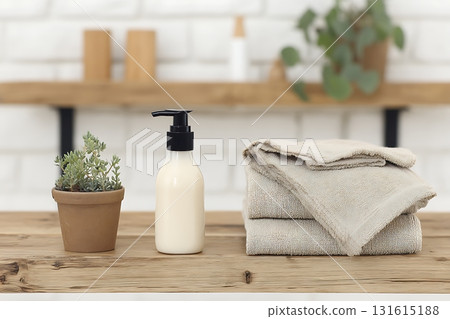 Elegant Bathroom Setup with Lotion Bottle, Towels, Succulent Plant and Minimalist Decor 131615188