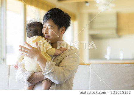 Dad holding a baby Dad holding a baby 131615192