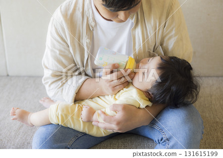 Dad holding a baby Dad holding a baby 131615199