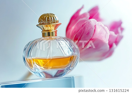 Elegant Perfume Bottle with Golden Cap and Pink Flower in Soft Focus Background Elegant Perfume Bottle with Golden Cap and Pink Flower in Soft Focus Background 131615224
