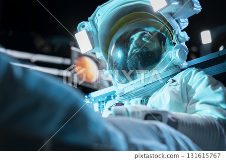 Cosmonaut losing hope, fainting after space station catastrophe during journey to Mars. Blue lights flashing over man despairing after spaceship getting damaged during red planet voyage Cosmonaut losing hope, fainting after space station catastrophe during journey to Mars. Blue lights flashing over man despairing after spaceship getting damaged during red planet voyage 131615767
