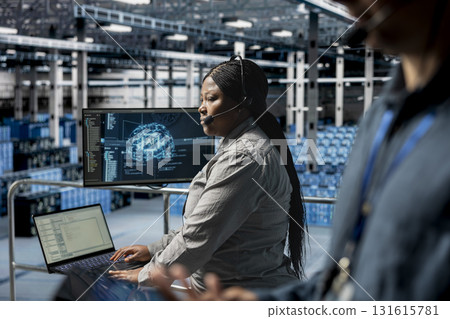 Server hub technicians diagnosing hardware failures using AI support systems, guiding users. Teamworking data center coworkers using headset mic, using automated AI scripts to resolve clients issues 131615781