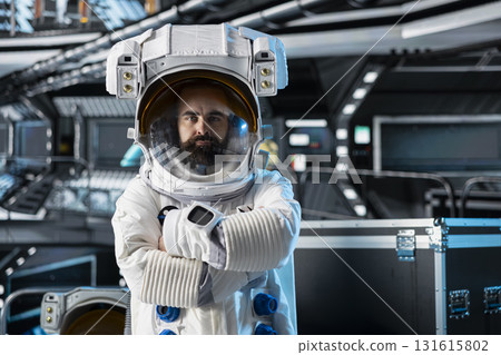 Portrait of astronaut testing helmet systems during routine equipment check inside orbital station. Spaceship crew member running diagnostics to confirm suit integrity and mission readiness Portrait of astronaut testing helmet systems during routine equipment check inside orbital station. Spaceship crew member running diagnostics to confirm suit integrity and mission readiness 131615802
