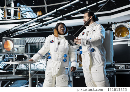 Cosmonauts in spaceship navigating orbital trajectory, doing Mars expedition for future of mankind. Astronauts mapping unknown worlds, exploring red planet to support human life beyond Earth Cosmonauts in spaceship navigating orbital trajectory, doing Mars expedition for future of mankind. Astronauts mapping unknown worlds, exploring red planet to support human life beyond Earth 131615853