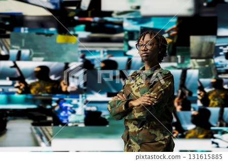 Portrait of soldier in command center housing missile defense system in front of multimedia backdrop. Woman in armed forces headquarters used for tracking rockets using radar systems 131615885