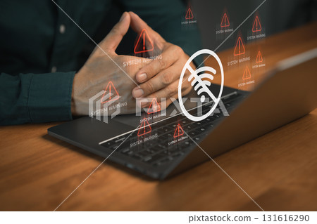 Person using laptop computer with warning icon and a no Wi-Fi signal symbol. Idea for IT security service and digital risk content, digital error, internet connection failure, malware, data breaches. Person using laptop computer with warning icon and a no Wi-Fi signal symbol. Idea for IT security service and digital risk content, digital error, internet connection failure, malware, data breaches. 131616290