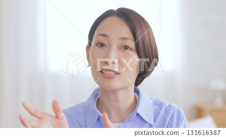 Woman speaking into the camera Woman speaking into the camera 131616387