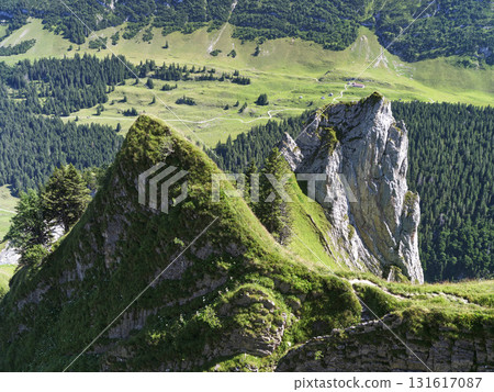 Stunning mountain landscape with rocky peaks and lush green valleys in the Swiss Alps during summer Stunning mountain landscape with rocky peaks and lush green valleys in the Swiss Alps during summer 131617087
