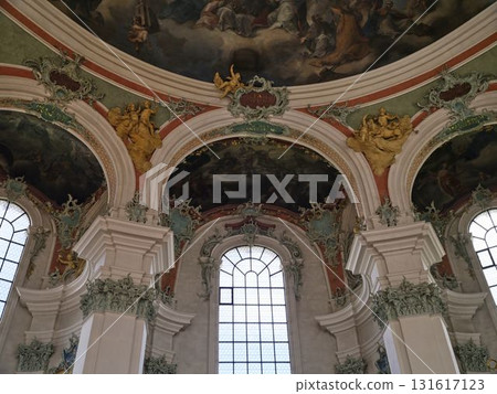 Magnificent interior details of a historic church featuring elaborate artwork and grand architectural elements during daylight 131617123