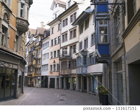 Charming cobblestone street in a historic town with colorful buildings and peaceful atmosphere Charming cobblestone street in a historic town with colorful buildings and peaceful atmosphere 131617151