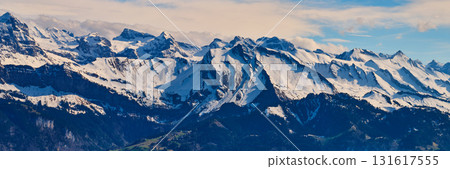 Mountains covered in snow with a clear blue sky overhead during daytime 131617555