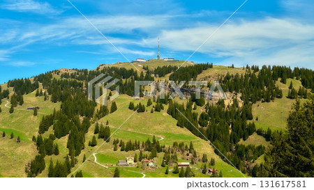 Scenic view of green hills and a mountain peak under a clear blue sky in summer 131617581