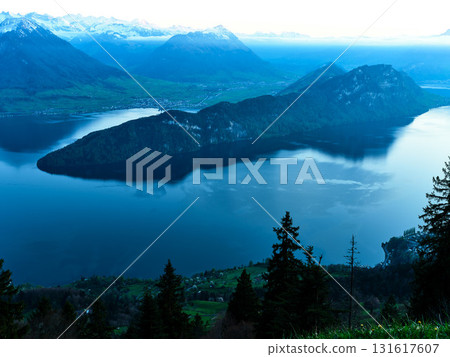 Serene twilight view of Lake Lucerne with mountains and island in Switzerland Serene twilight view of Lake Lucerne with mountains and island in Switzerland 131617607