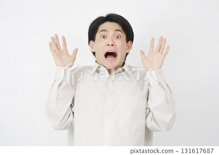 Man in his 20s, surprised, white background Man in his 20s, surprised, white background 131617687