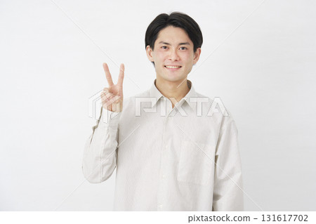 Man in his 20s, peace sign, white background 131617702