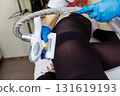 LPG massage procedure for removing subcutaneous fat from a young woman. 131619193