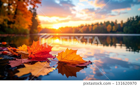 Beautiful autumn nature landscape of a forest and trees reflecting in calm lake water with clouds and mountains in the sky Beautiful autumn nature landscape of a forest and trees reflecting in calm lake water with clouds and mountains in the sky 131620970