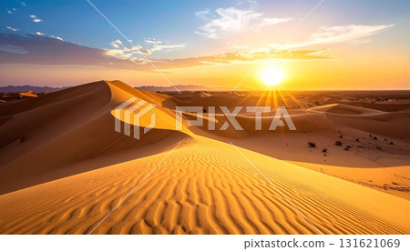 Sahara sunset paints the sand dunes in a fiery orange glow, highlighting the arid landscape for a memorable travel adventure 131621069
