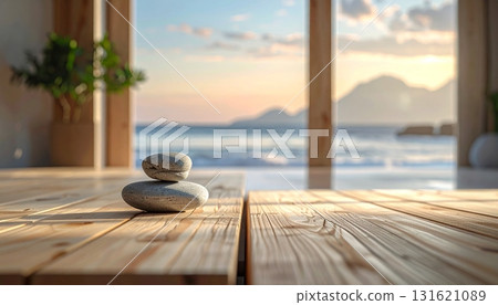 Smooth gray zen stones stacked for balance and harmony on a wooden table 131621089