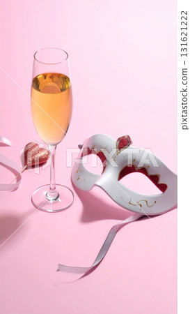 Two glasses of champagne and gold confetti for a masquerade celebration 131621222
