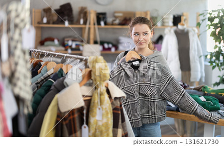 Woman choosing a cropped coat Woman choosing a cropped coat 131621730