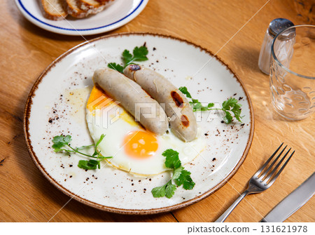 Delicious hearty breakfast with scrambled eggs and sausage closeup Delicious hearty breakfast with scrambled eggs and sausage closeup 131621978