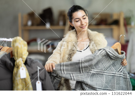 Armenian chooses a coat in the store 131622044