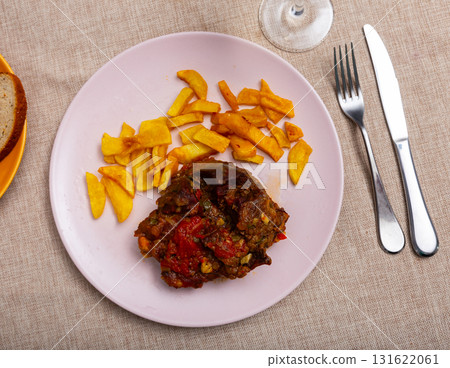 Baked pork cheek served with vegetables 131622061