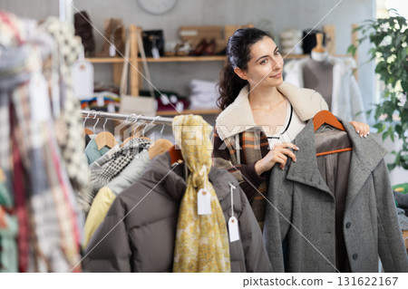 Armenian chooses a coat in the store Armenian chooses a coat in the store 131622167