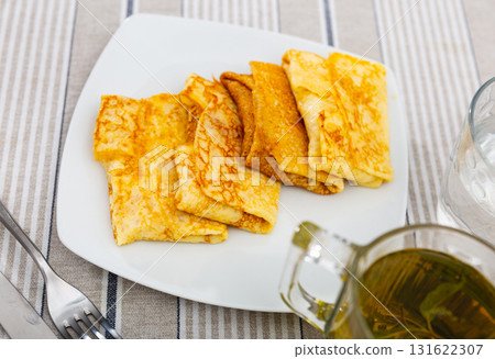 Pancakes stuffed with meat served on platter 131622307