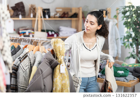 Armenian woman choosing clothes for autumn and winter in the store Armenian woman choosing clothes for autumn and winter in the store 131622357