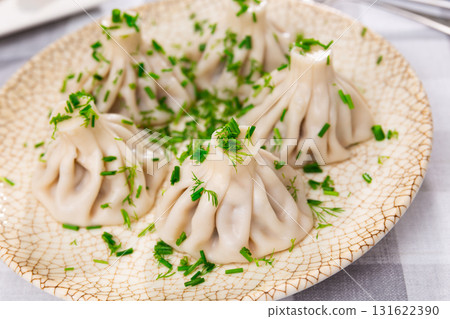 There is portion of khinkali on plate - national Georgian dish made of dough and meat There is portion of khinkali on plate - national Georgian dish made of dough and meat 131622390