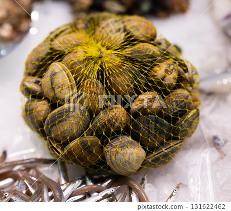 Raw shellfish in a net at fish market - freshly caught shellfish 131622462