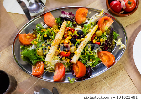 Traditional Spanish mixed salad, made from corn, tomato, lettuce, olives, asparagus, bell peppers 131622481