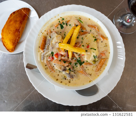 Latin American peanut soup sopa de mani with empanada 131622581