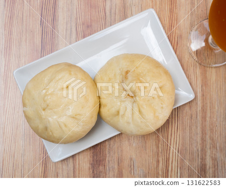 There is portion of pan chino buns with minced meat on plate - traditional Asian baozi 131622583