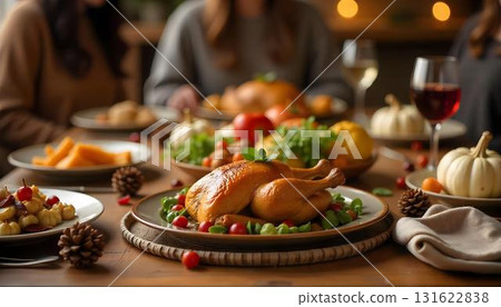 A cozy group of people gathered around a table, enjoying a Thanksgiving meal with turkey and pumpkin pie in a warm home setting 131622838