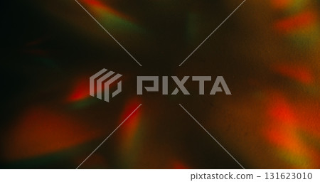 Crystal leak. Blur color background. Orange green rainbow glare shadow gleam reflection on warm art illuminated dark black abstraction. Crystal leak. Blur color background. Orange green rainbow glare shadow gleam reflection on warm art illuminated dark black abstraction. 131623010