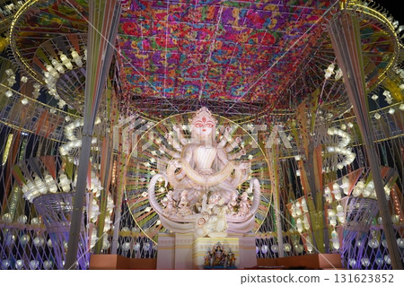 White Goddess Durga Idol in Modern Illuminated Pandal with Colorful Ceiling White Goddess Durga Idol in Modern Illuminated Pandal with Colorful Ceiling 131623852