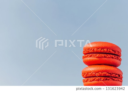 Red macarons stacked against a clear blue sky during a sunny day Red macarons stacked against a clear blue sky during a sunny day 131623942