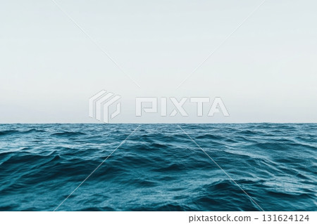 Wide view of a calm ocean under a clear sky in the early morning 131624124