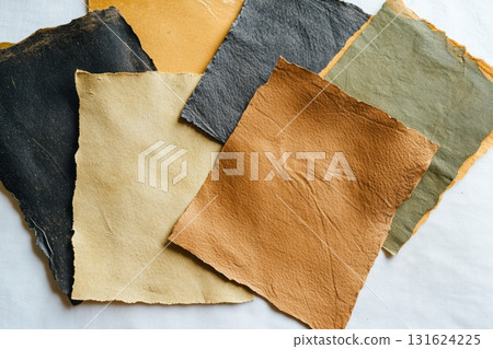 Variety of textured leather swatches in natural colors on a neutral background 131624225